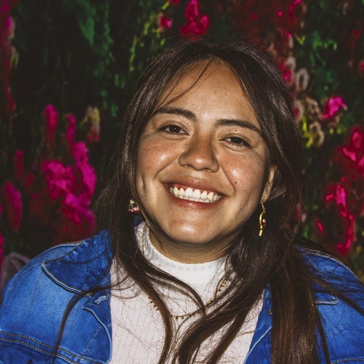 Alex Rivera, Lead Design Curator at WhisperingRiverForest, reviewing corporate floral arrangements